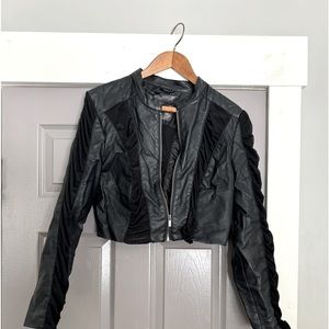 Woman’s bolero jacket leather like with sheer stripes on arms and down the back